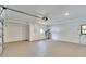 Clean garage featuring painted floor, door to outside, and garage door opener at 11283 Portsmouth St, Spring Hill, FL 34609
