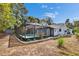 Aerial backyard view showcasing a screened pool with an updated patio deck and privacy landscaping at 11283 Portsmouth St, Spring Hill, FL 34609