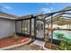 Backyard featuring a screened pool and outdoor seating area, seamlessly blending indoor and outdoor living at 11283 Portsmouth St, Spring Hill, FL 34609