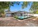 Backyard featuring a screened pool and outdoor garden, creating a peaceful retreat for leisure and entertainment at 11283 Portsmouth St, Spring Hill, FL 34609