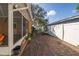 View of the brick-paved patio and lush landscaping leading to the backyard at 11351 130Th Ave, Largo, FL 33778