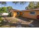 Backyard view with stone pavers, landscaping, and exterior of the house at 11351 130Th Ave, Largo, FL 33778