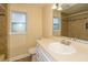 Bathroom features light vanity and countertop, with a view of the glass tiled shower at 11351 130Th Ave, Largo, FL 33778