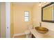 Bathroom features designer glass bowl sink and decorative mirror, with toilet and window at 11351 130Th Ave, Largo, FL 33778