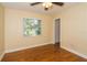 Modest bedroom features hardwood floors, a ceiling fan, and a window that provides natural light at 11351 130Th Ave, Largo, FL 33778