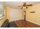 Bedroom features hardwood floors, closet with folding doors, and ceiling fan with light at 11351 130Th Ave, Largo, FL 33778