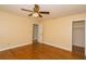 Bedroom features ceiling fan with light, hardwood floors, and neutral color palette at 11351 130Th Ave, Largo, FL 33778