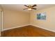 A standard bedroom with hardwood floors, a ceiling fan, and a window for natural light at 11351 130Th Ave, Largo, FL 33778