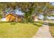 Street view of the home's exterior, showcasing mature trees and well-maintained lawn at 11351 130Th Ave, Largo, FL 33778