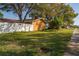 Exterior view of the house from the side yard, showing the lawn and white fence at 11351 130Th Ave, Largo, FL 33778