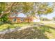 A single-story home with a well-maintained lawn and mature tree in the front yard at 11351 130Th Ave, Largo, FL 33778