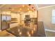 Well-lit kitchen featuring a breakfast bar with granite countertop and stainless steel appliances at 11351 130Th Ave, Largo, FL 33778