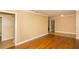 Neutral living room with hardwood floors, crown molding, and doorway at 11351 130Th Ave, Largo, FL 33778