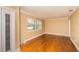 Bright living room with hardwood floors, window with blinds, and white trim molding at 11351 130Th Ave, Largo, FL 33778