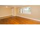 Bright living room featuring hardwood floors, crown molding, and a large window at 11351 130Th Ave, Largo, FL 33778