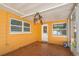 Enclosed sun room features neutral paint, tile floor, windows, and a ceiling fan at 11351 130Th Ave, Largo, FL 33778