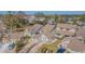 Aerial view showing a collection of townhomes with a mix of beige exteriors, brown roofs, and tree landscaping at 11743 Rolling Pine Ln, Port Richey, FL 34668