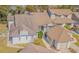 Neutral exterior showing a well-maintained home with a brown roof and attached garage at 11743 Rolling Pine Ln, Port Richey, FL 34668