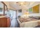 Comfortable bedroom features a vaulted ceiling, sliding glass doors, and decorative artwork at 11743 Rolling Pine Ln, Port Richey, FL 34668
