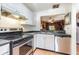 Cozy kitchen featuring white cabinetry, stainless steel appliances, and tile floors at 11743 Rolling Pine Ln, Port Richey, FL 34668