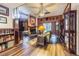 Living room with wood floors, fireplace, ceiling fan, and ample natural light at 11743 Rolling Pine Ln, Port Richey, FL 34668
