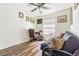 Home office with a comfortable futon, dark wood-look flooring, and lots of natural light at 11743 Rolling Pine Ln, Port Richey, FL 34668