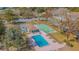 Aerial view of a community pool, shuffleboard court, and playground at 11743 Rolling Pine Ln, Port Richey, FL 34668