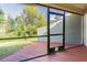Screened porch offers a view of the lush backyard and a serene outdoor living space at 11743 Rolling Pine Ln, Port Richey, FL 34668