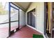 Screened porch with wood flooring and a view of the backyard at 11743 Rolling Pine Ln, Port Richey, FL 34668