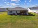 Large backyard showcases manicured lawn, a patio, and the rear of the house at 11912 Richmond Trl, Parrish, FL 34219