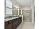 Modern bathroom featuring granite countertops, and sinks and a glass enclosed shower at 11912 Richmond Trl, Parrish, FL 34219