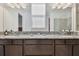 Bathroom vanity with granite countertop, and sinks and a large mirror at 11912 Richmond Trl, Parrish, FL 34219