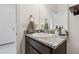 Bathroom features a dark vanity with granite countertop, decorative accents, and a framed mirror at 11912 Richmond Trl, Parrish, FL 34219