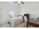 Cozy bedroom with a bed, desk, and a large window offering natural light at 11912 Richmond Trl, Parrish, FL 34219