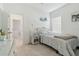 Bright bedroom with a white wicker bed frame, bedside table, and beachy decorative accents at 11912 Richmond Trl, Parrish, FL 34219