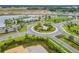 Overhead view of landscaped community roundabout, with a playground and pond in the distance at 11912 Richmond Trl, Parrish, FL 34219