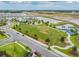 Aerial view of a new community park with playground, soccer field and walking paths near a pond at 11912 Richmond Trl, Parrish, FL 34219