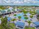 Stunning aerial view of the community pool and lounging area, lined with mature palm trees and shaded seating at 11912 Richmond Trl, Parrish, FL 34219