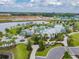 Aerial view of the community pool with palm trees and clubhouse offering a resort-style experience at 11912 Richmond Trl, Parrish, FL 34219