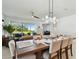 Bright dining room with large windows offering backyard views and plenty of seating for entertaining at 11912 Richmond Trl, Parrish, FL 34219