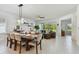 Spacious dining room with a large table, stylish lighting, and a view of the outdoor living space at 11912 Richmond Trl, Parrish, FL 34219