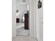 Hallway view towards Primary bedroom showcasing a dresser and mirror; laundry room door visible at 11912 Richmond Trl, Parrish, FL 34219