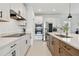Modern kitchen features white cabinetry, stainless steel appliances, and a spacious quartz countertop at 11912 Richmond Trl, Parrish, FL 34219