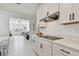 Modern kitchen featuring white cabinets, granite countertops and stainless steel appliances overlooking the living room at 11912 Richmond Trl, Parrish, FL 34219