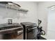 Modern laundry room featuring front load washer and dryer at 11912 Richmond Trl, Parrish, FL 34219