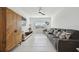 Spacious living room with a sectional sofa, decorative wood cabinet, and modern lighting at 11912 Richmond Trl, Parrish, FL 34219