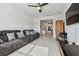 Cozy living room showcases a plush sofa, flat-screen TV, and view into the modern kitchen at 11912 Richmond Trl, Parrish, FL 34219