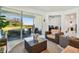Inviting living space featuring wicker furnishings, a glass coffee table and sliding doors to the screened patio at 11912 Richmond Trl, Parrish, FL 34219