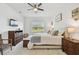 Bedroom with king bed, modern decor, natural light from the window, with a ceiling fan at 11912 Richmond Trl, Parrish, FL 34219