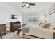 Main bedroom featuring a king bed, mounted TV, and window with natural light at 11912 Richmond Trl, Parrish, FL 34219